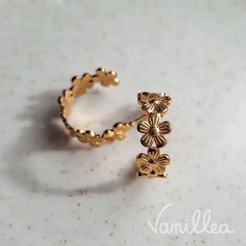 dĂ©tail des boucles dâoreilles fleurs dorĂ©es minimalistes